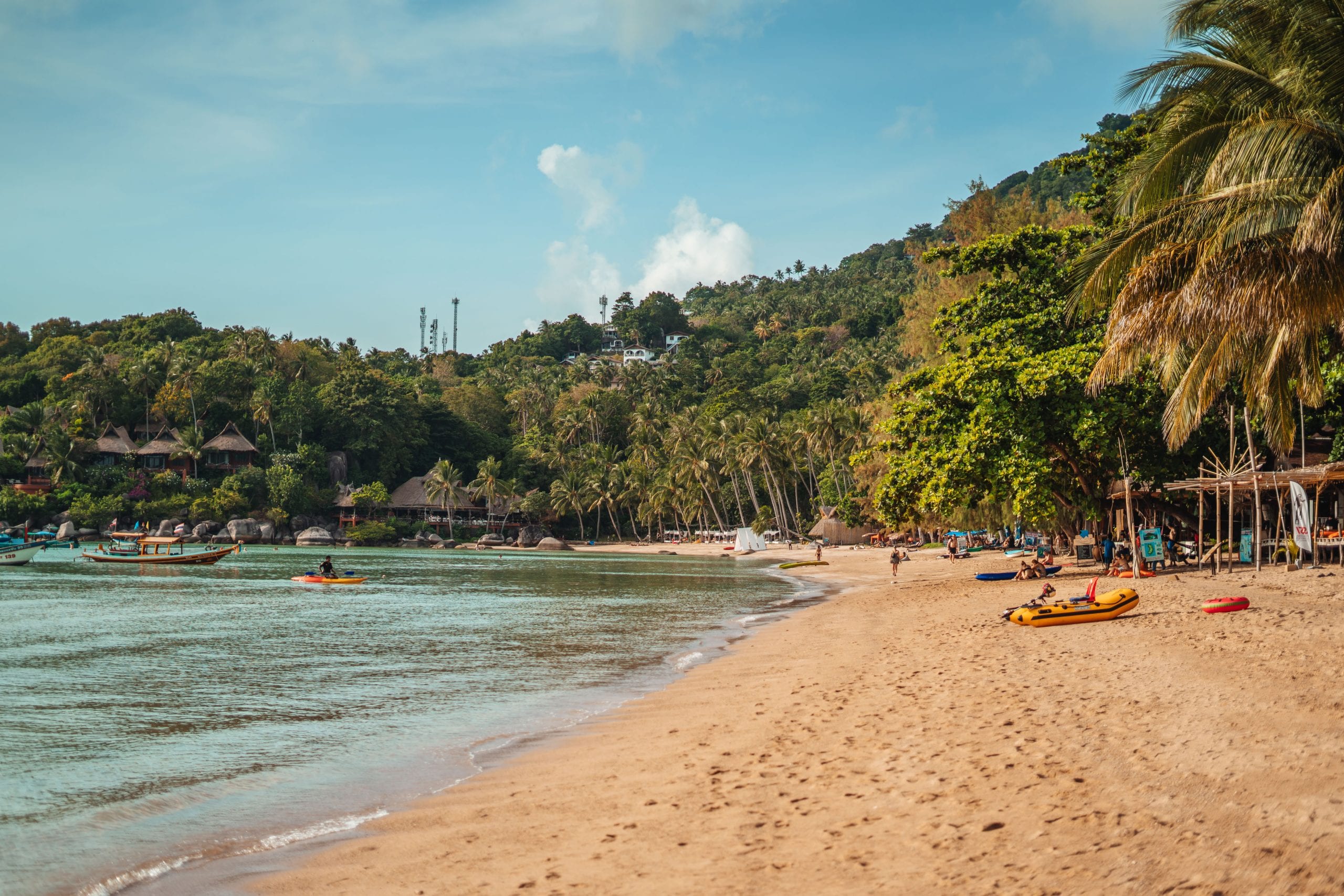 Sairee Beach in the afternoon, kayaks pulled up on soft white sand