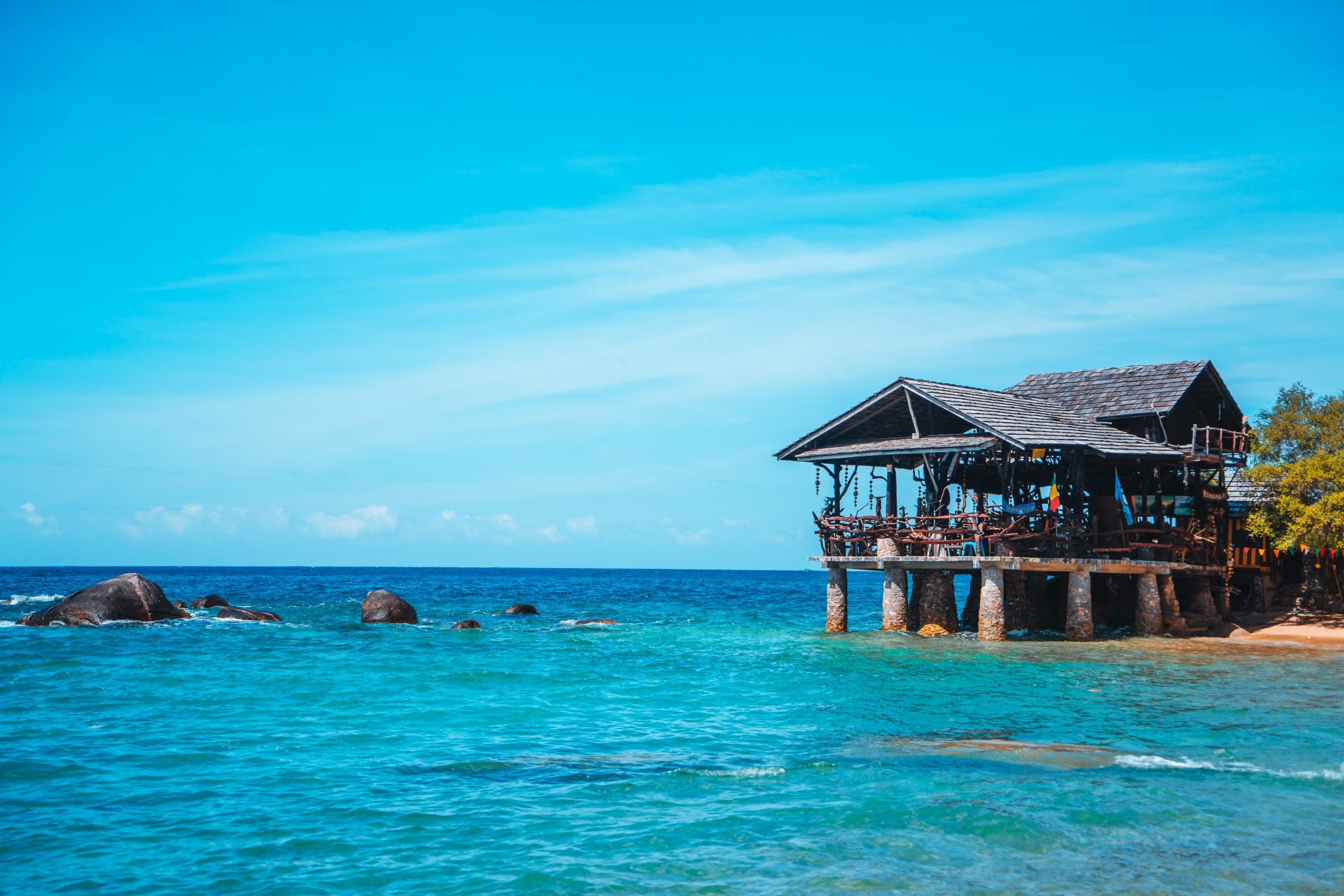 An open-sided pavilion restaurant over the water on Koh Tao
