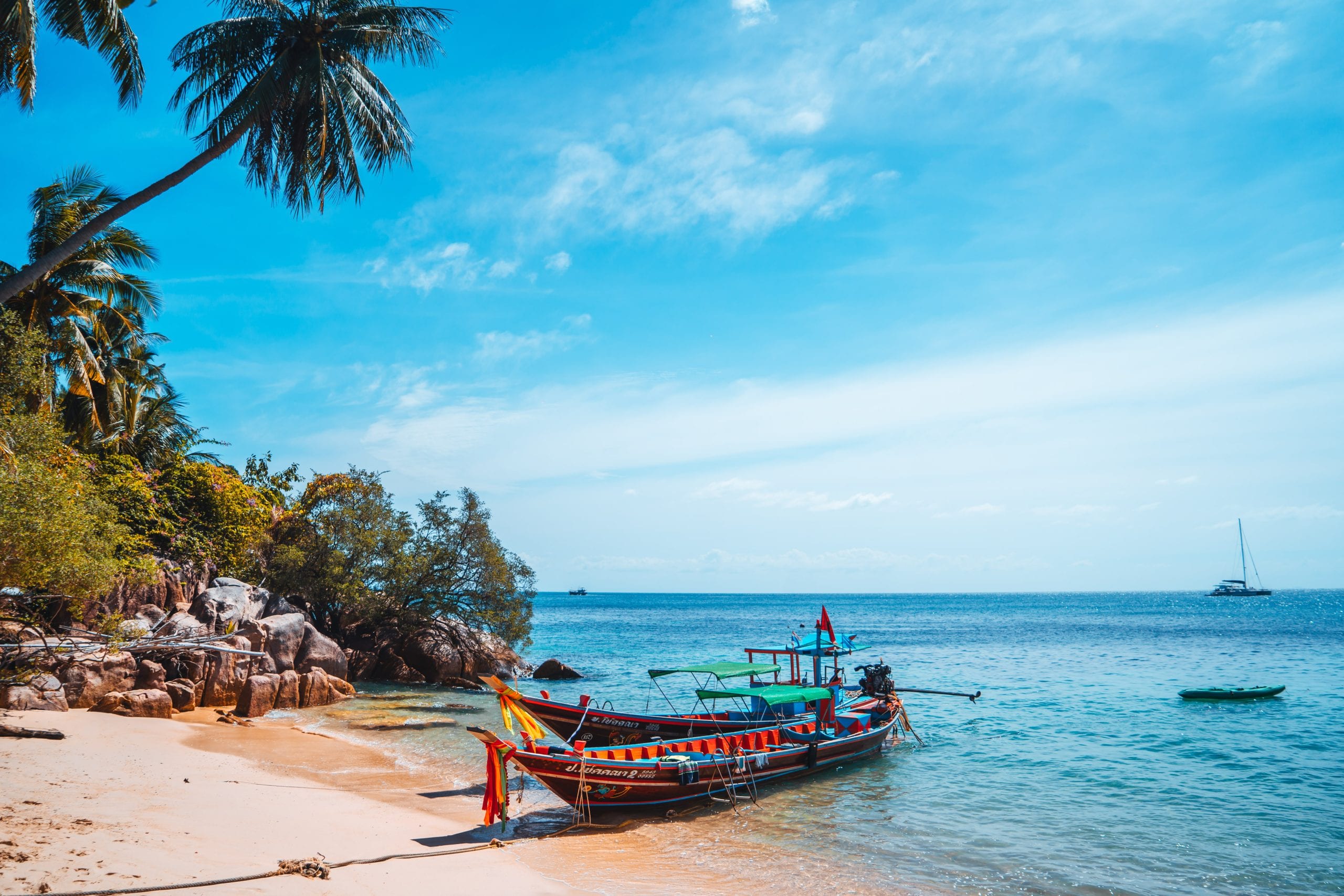 Longtail boats on a Koh Tao beach, the transport that shapes an island day