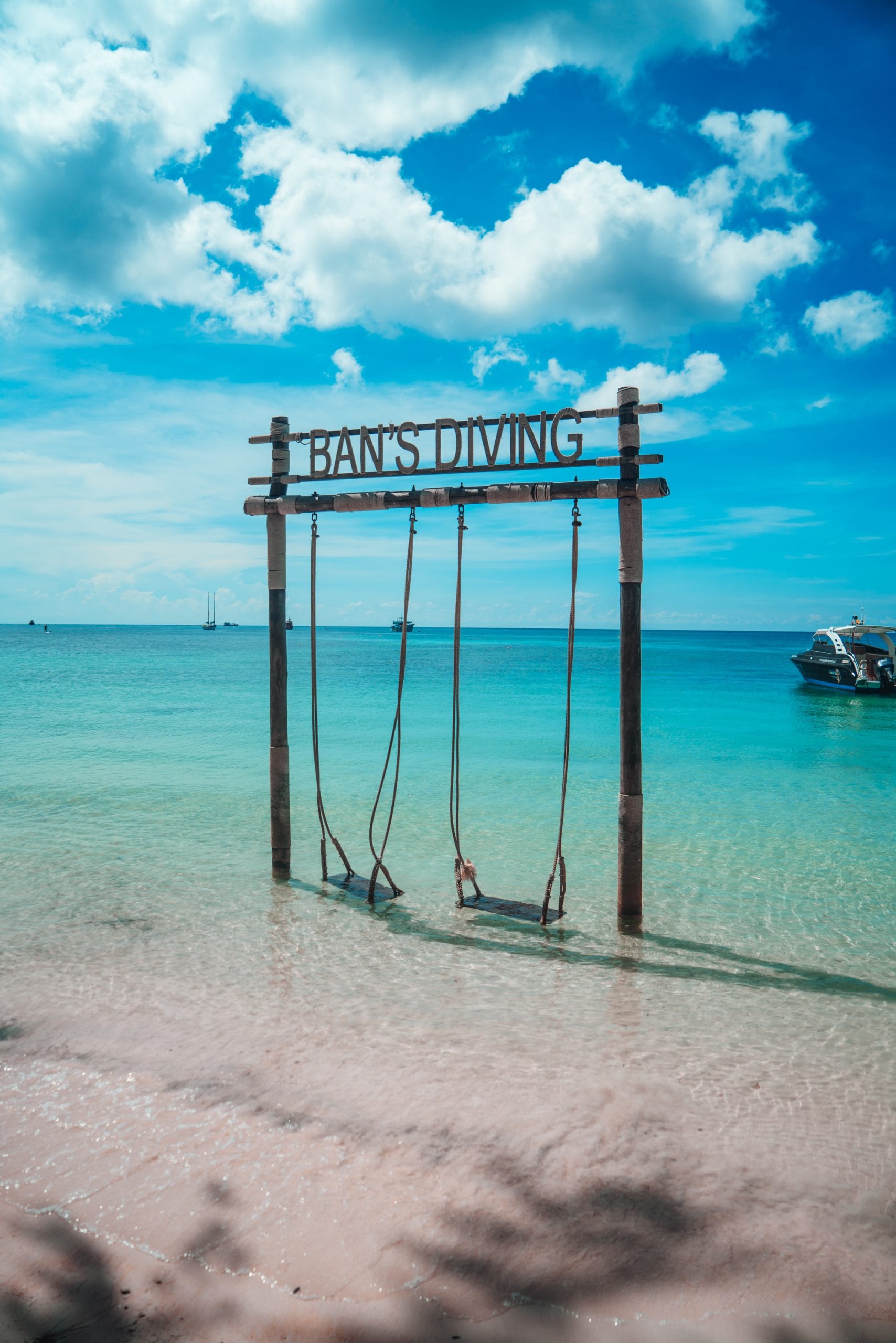 A dive school sign on the beach front at Sairee